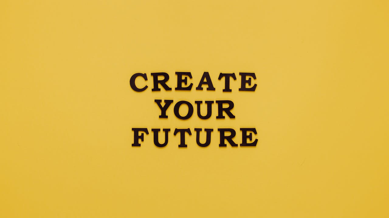 Bold text 'CREATE YOUR FUTURE' on minimalist yellow background. Inspiring design.